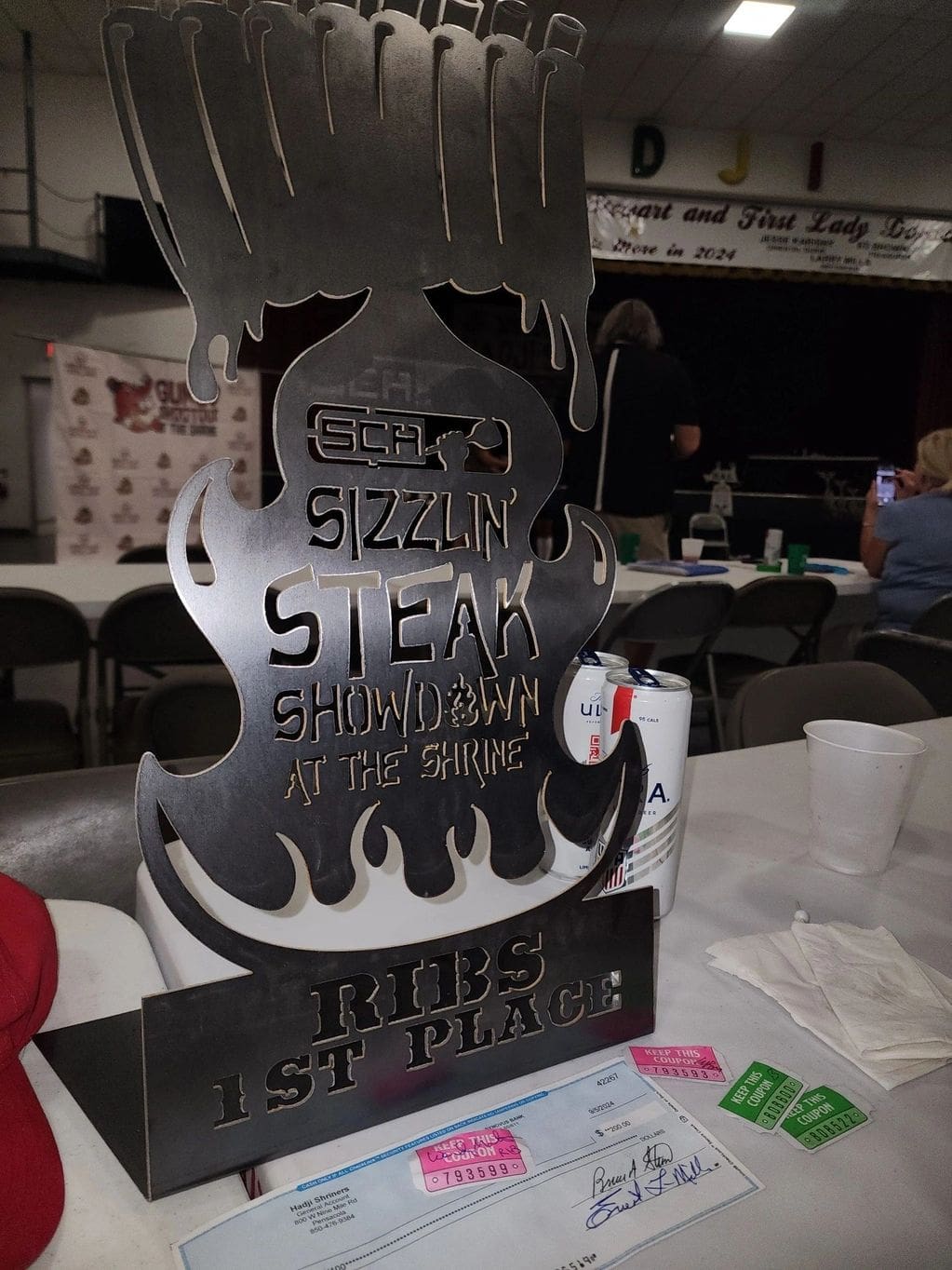 A metal sign sitting on top of a table.